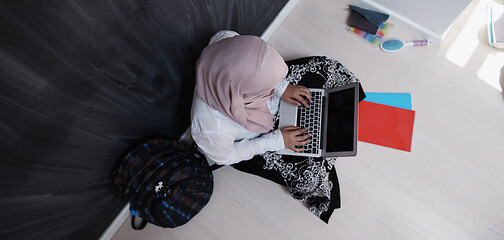 Image showing arab female student working on laptop from home