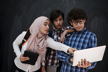 Image showing Arab teenagers group working on laptop and tablet computer