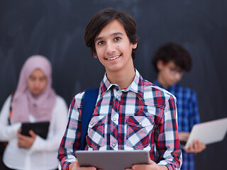 Image showing Arab teenagers group working on laptop and tablet computer