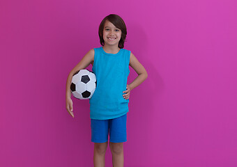 Image showing Arabic boy with soccer ball against  pink background