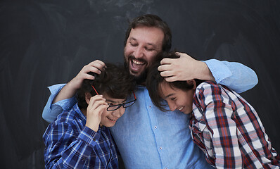 Image showing happy father hugging sons