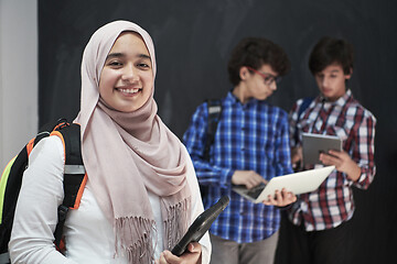 Image showing Arab teenagers group working on laptop and tablet computer