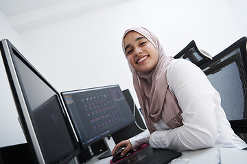 Image showing Arabic creative professional  working at home office on desktop 