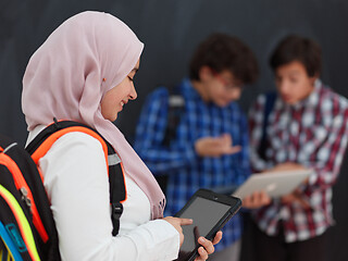 Image showing Arab teenagers group working on laptop and tablet computer