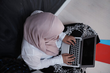 Image showing arab female student working on laptop from home