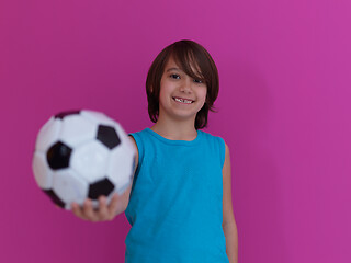 Image showing Arabic boy with soccer ball against  pink background