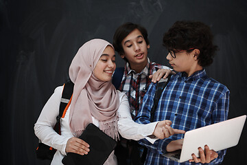 Image showing Arab teenagers group working on laptop and tablet computer