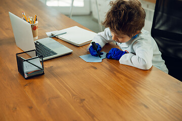 Image showing Little caucasian boy as a doctor consulting for patient, working in cabinet, close up