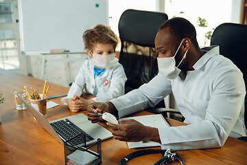 Image showing Little caucasian boy as a doctor consulting for patient, working in cabinet, close up