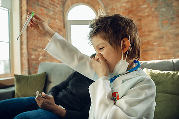 Image showing Little caucasian boy as a doctor consulting for patient, working in cabinet, close up