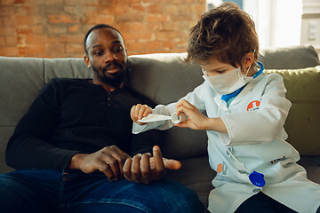 Image showing Little caucasian boy as a doctor consulting for patient, working in cabinet, close up