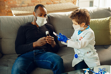 Image showing Little caucasian boy as a doctor consulting for patient, working in cabinet, close up