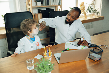 Image showing Little caucasian boy as a doctor consulting for patient, working in cabinet, close up