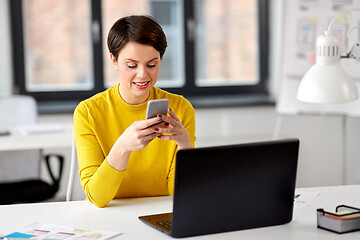 Image showing smiling ui designer using smartphone at office