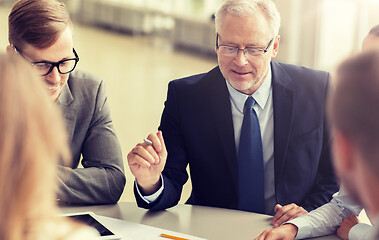 Image showing architects with tablet pc and blueprint at office