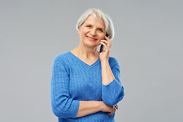 Image showing smiling senior woman calling on smartphone