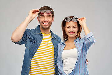 Image showing happy couple in sunglasses over grey background