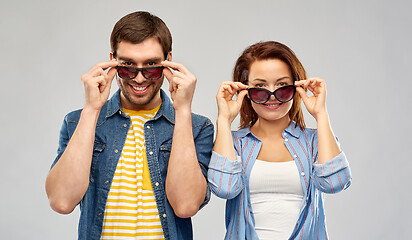 Image showing happy couple in sunglasses over grey background