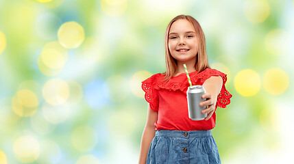 Image showing smiling preteen girl drinking soda from can