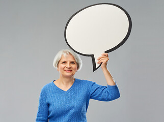 Image showing smiling senior woman holding big speech bubble
