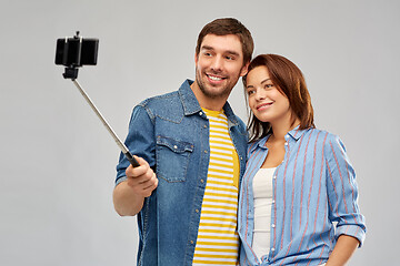 Image showing happy couple taking selfie by smartphone