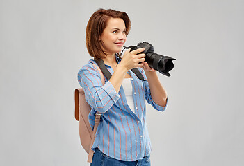 Image showing happy tourist woman with backpack and camera