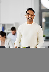 Image showing happy male office worker with personal stuff