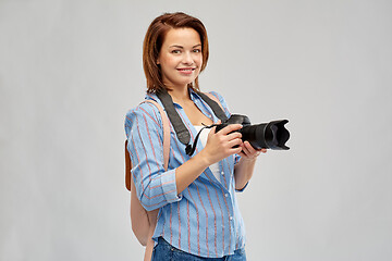 Image showing happy tourist woman with backpack and camera