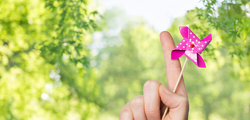 Image showing close up of hand holding pinwheel toy