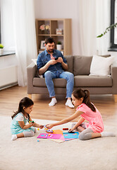 Image showing happy sisters doing arts and crafts at home