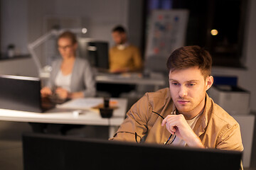 Image showing man with computer working late at night office