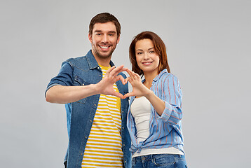 Image showing happy couple making hand heart