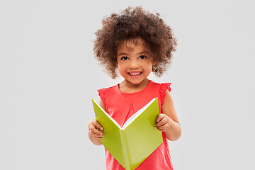 Image showing happy little african american girl reading book