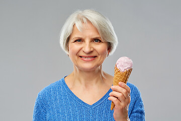 Image showing portrait of smiling senior woman with ice cream