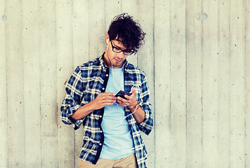 Image showing man with earphones and smartphone listening music