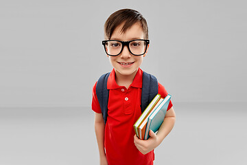 Image showing smiling student boy in glasses with books and bag