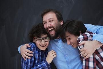 Image showing happy father hugging sons