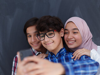 Image showing group of arab teens taking selfie photo on smart phone