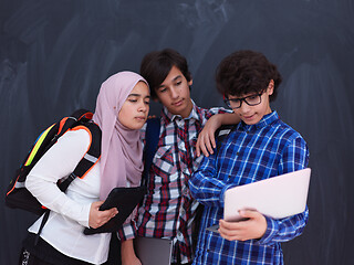 Image showing Arab teenagers group working on laptop and tablet computer