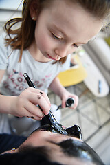 Image showing mother and daughter at home making facial mask beauty treatment