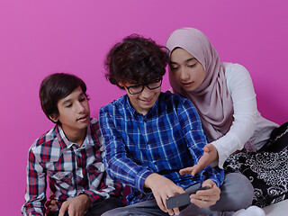 Image showing arab teenagers group using smart phones online education