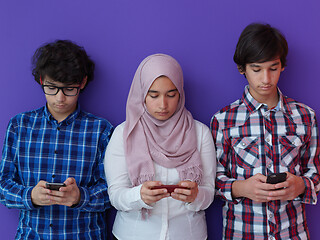 Image showing arab teenagers group using smart phones online education