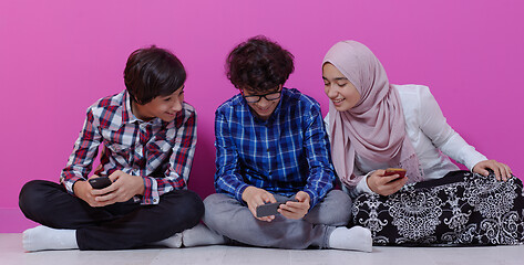 Image showing arab teenagers group using smart phones online education