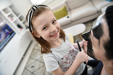 Image showing mother and daughter at home making facial mask beauty treatment