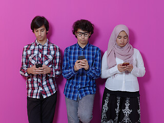 Image showing arab teenagers group using smart phones online education