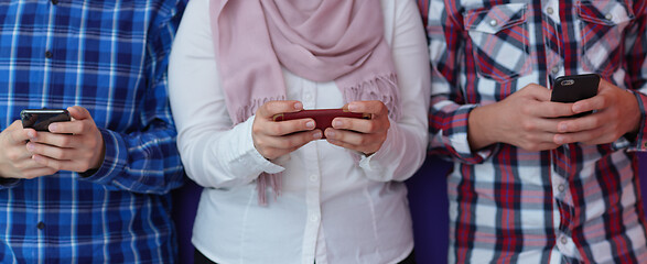 Image showing arab teenagers group using smart phones online education