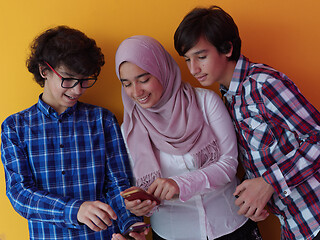 Image showing arab teenagers group using smart phones online education