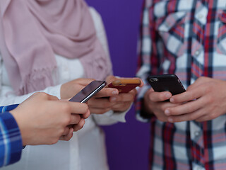 Image showing arab teenagers group using smart phones online education