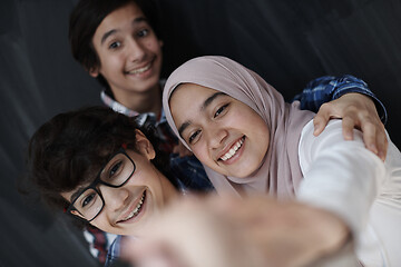 Image showing group of arab teens taking selfie photo on smart phone