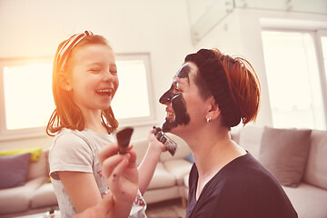 Image showing mother and daughter at home making facial mask beauty treatment